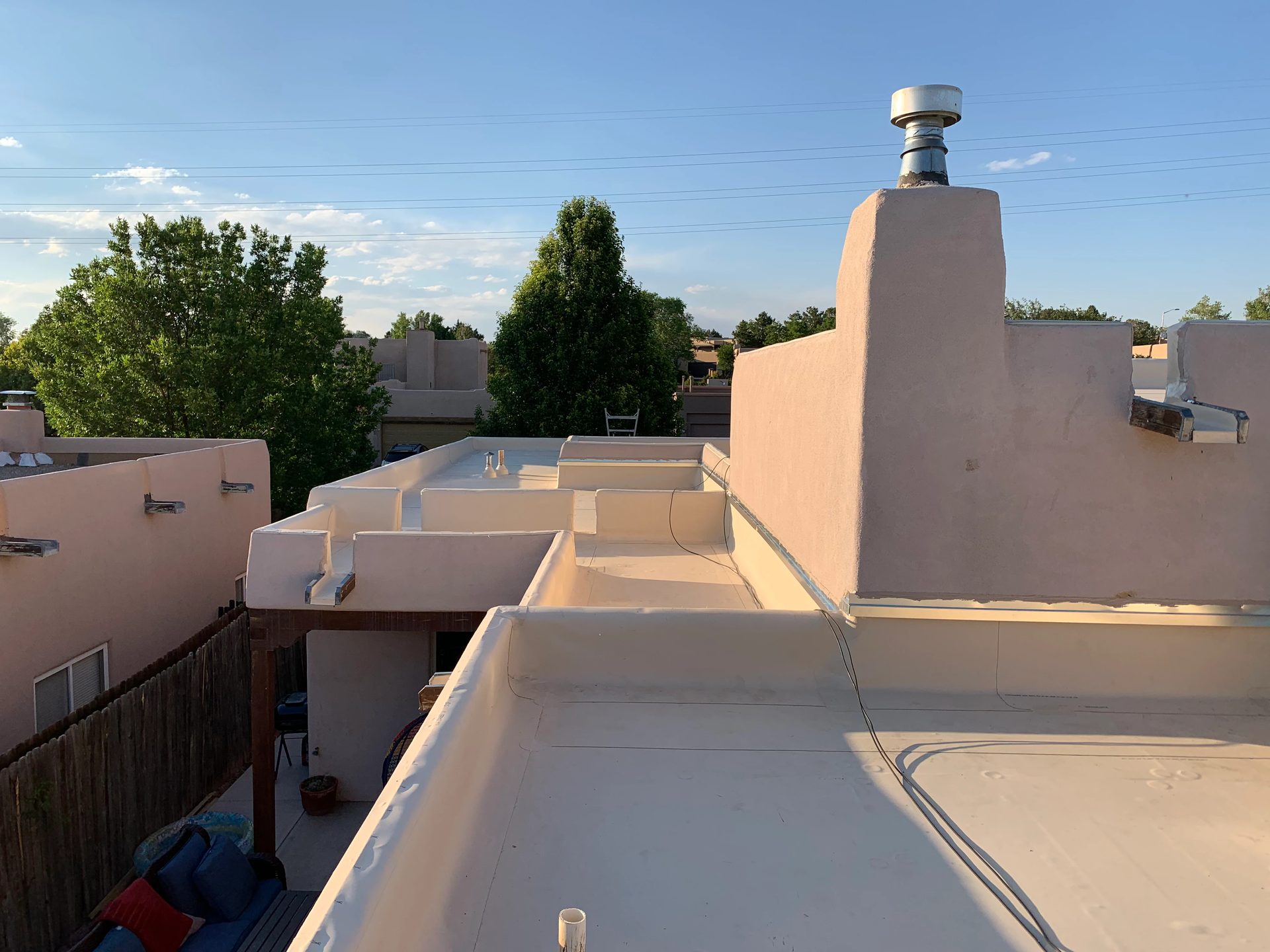 Flat foam roof with parapet walls on a Southwest home