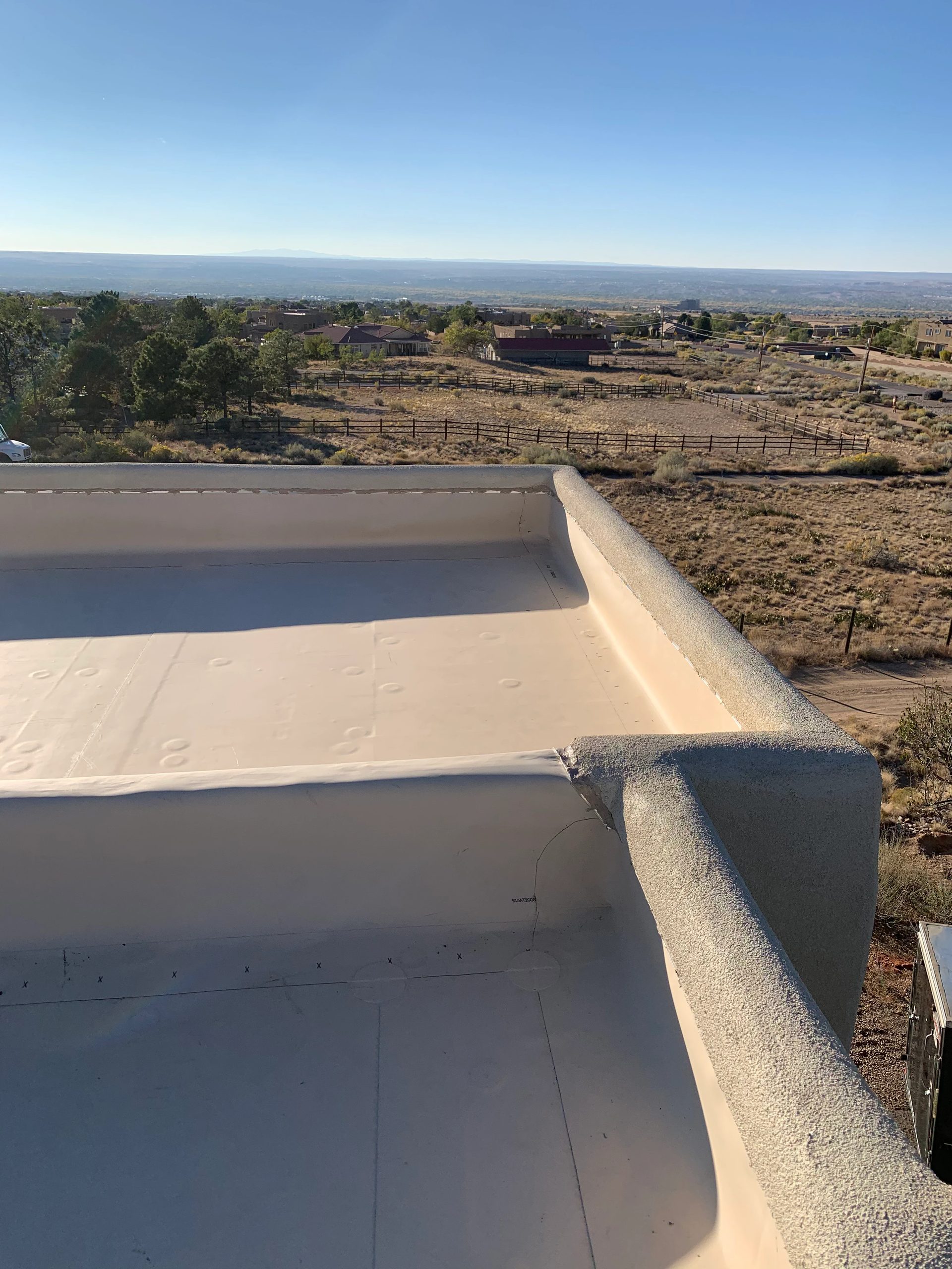 Flat foam roof with parapet walls overlooking the high desert