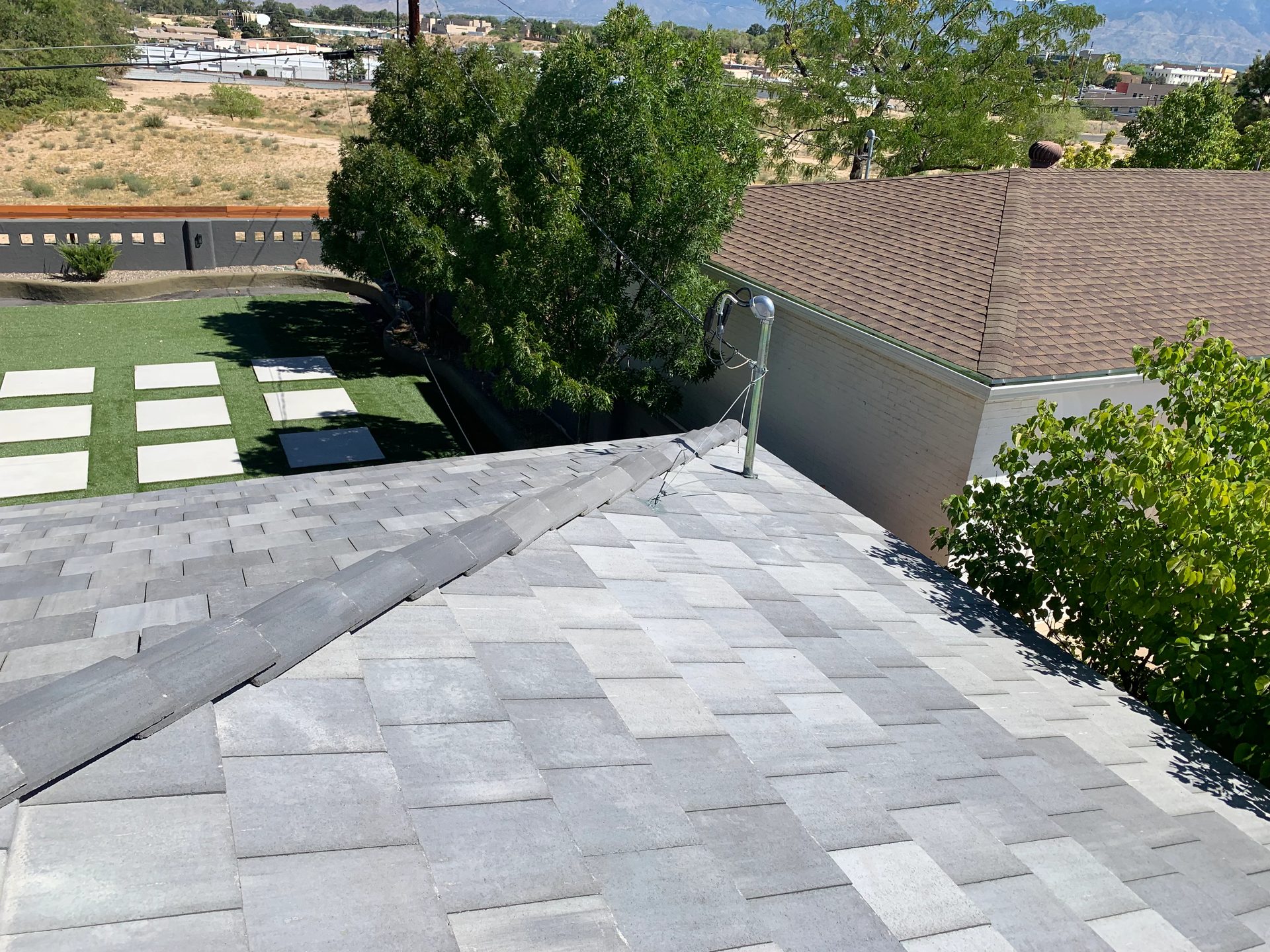 New grey asphalt shingle roof on a Southwest home